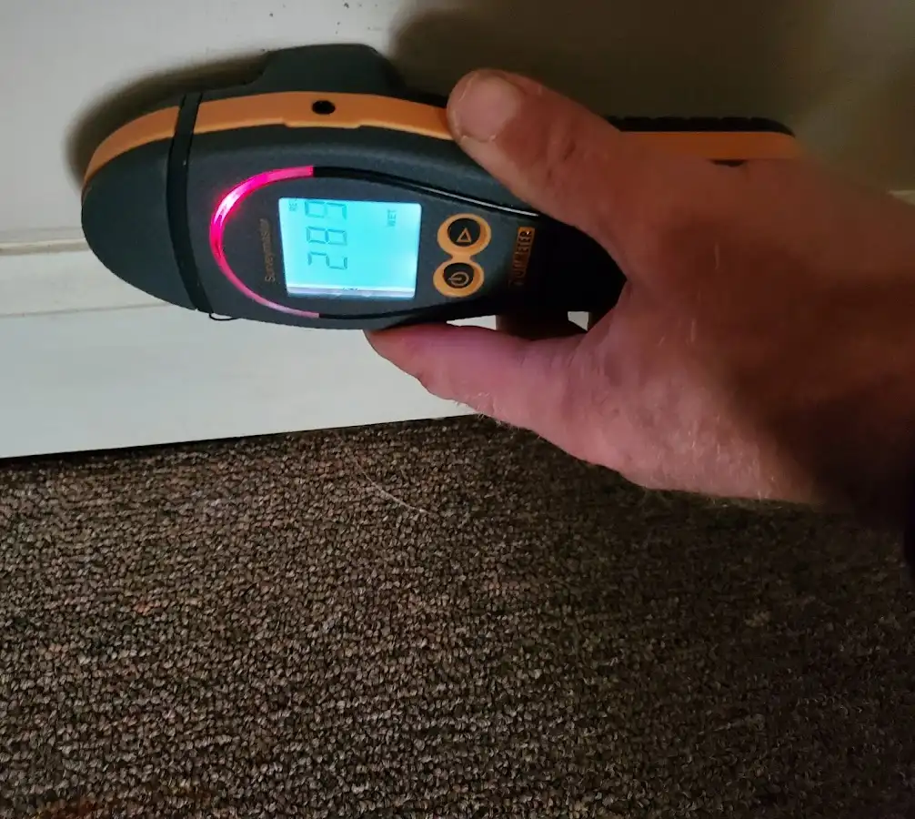 Moisture detection at baseboard during Storm Damage Restoration in Aspen Hill